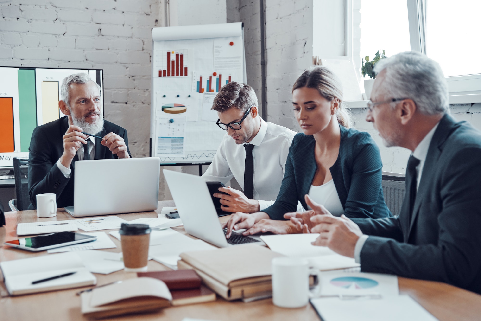 Successful business team analyzing strategy while working in the modern office